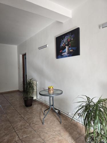 a table in a room with a painting on the wall at Vila Prahoveană in Eforie Nord