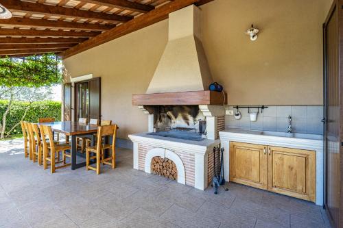an outdoor kitchen with a stove and a table at Villa Roza in Central Istria with whirlpool and playground for kids - pet friendly in Tinjan