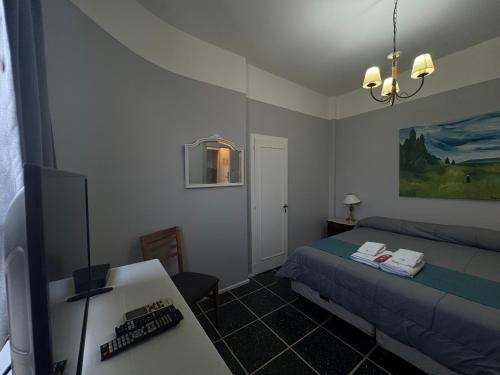a bedroom with a bed and a desk and a table at Hotel Lyon by MH in Buenos Aires