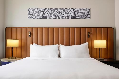 a bedroom with a large bed with two lamps at Arlo Chicago in Chicago