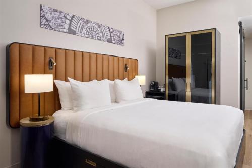 a large white bed in a hotel room at Arlo Chicago in Chicago