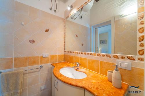a bathroom with a sink and a mirror at Villa Margherita - By Searly in Porto Rotondo