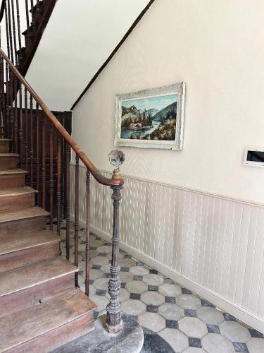 a staircase in a house with a painting on the wall at Maison Marguerite in Vic-en-Bigorre