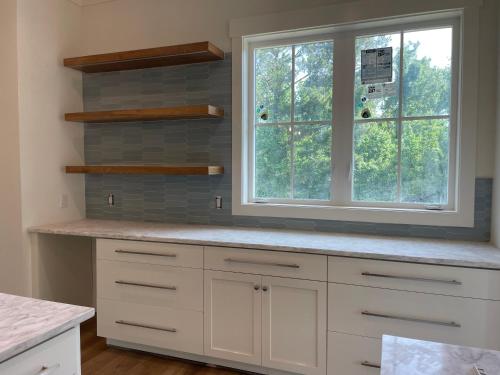 a kitchen with white cabinets and a window at 2 Abalone Ln, New Construction, Luxury Finishes, Pool, Game Room in Hilton Head Island