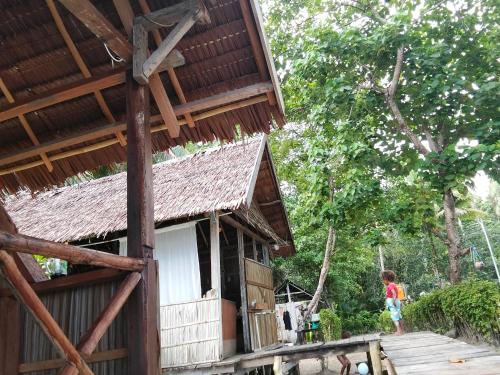 a child standing in front of a building at Nyandetor Homestay in Yennanas Besir