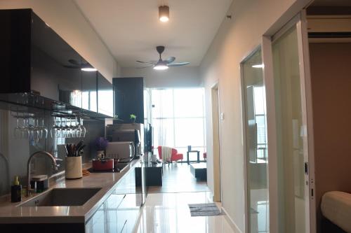a kitchen with a sink and a counter top at Maritime Suite by Ocean Luxe 2BR Seaview Dryer Water Dispenser in George Town