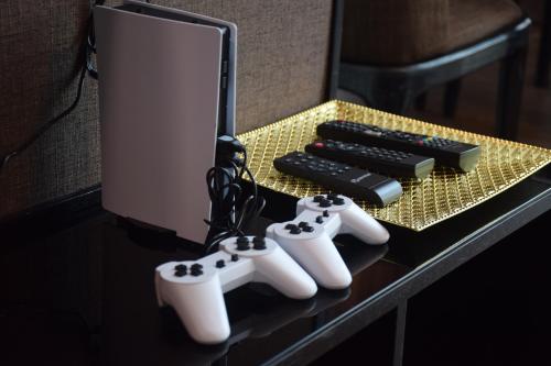 a table with three video game controllers and a keyboard at Maritime Suite by Ocean Luxe 2BR Seaview Dryer Water Dispenser in George Town