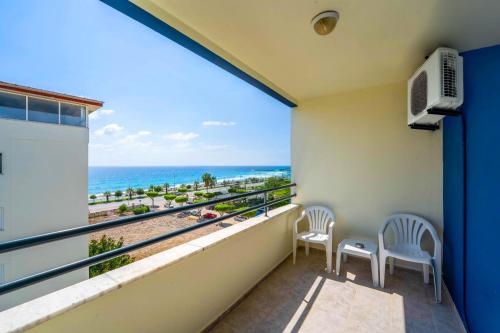 a balcony with two chairs and a view of the ocean at Galaxy Beach Hotel Alanya in Mahmutlar