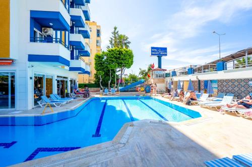 a large swimming pool in front of a building at Galaxy Beach Hotel Alanya in Mahmutlar