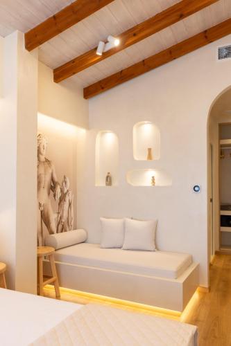 a room with a bed with a statue on the wall at Dimitri Hotel in Himare