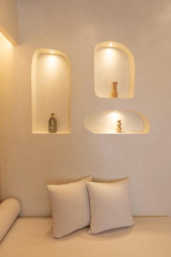a room with a couch with two mirrors and a sink at Dimitri Hotel in Himare