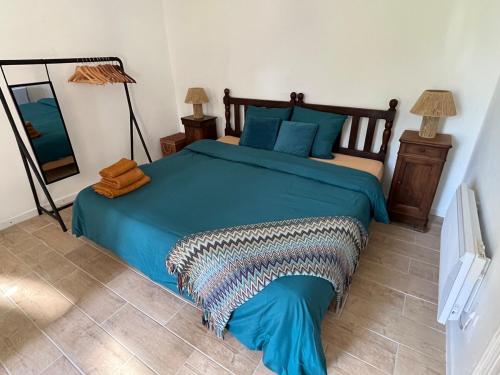 - une chambre avec un lit doté de draps bleus et d'oreillers bleus dans l'établissement Whitsundoles Gîte, à Eymet