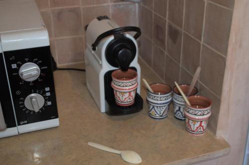 a coffee pot on a counter next to a toaster at Berberbayt lodge maison privé in Tinerhir