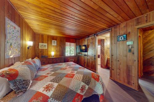 a bedroom with a bed in a wooden cabin at Nana and Papa's in Joseph