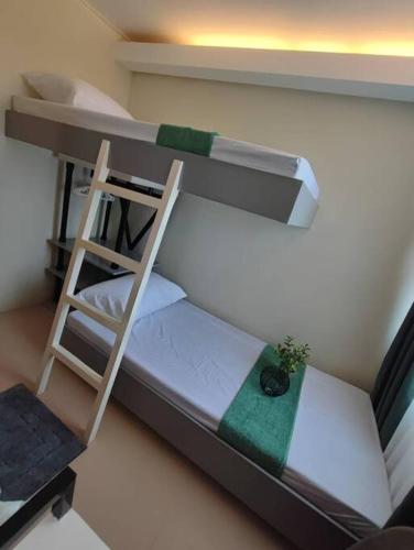 a scale model of a bunk bed with a ladder at Your home away from home in Piapi