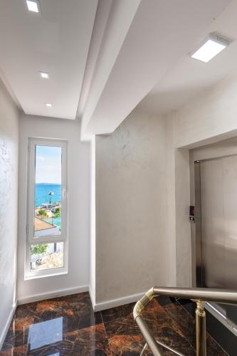 an empty room with a window and a staircase at Diamond Central Boutique Hotel in Sarandë
