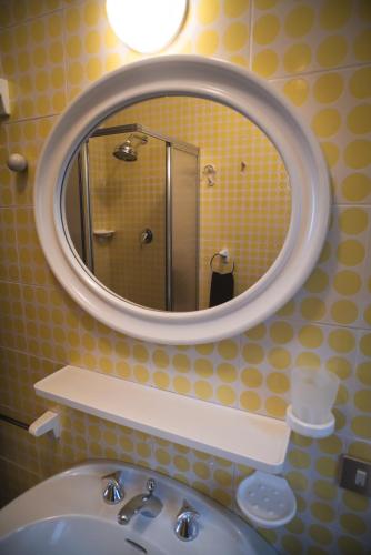 a bathroom with a sink and a mirror at Casa di Luca in Torri del Benaco