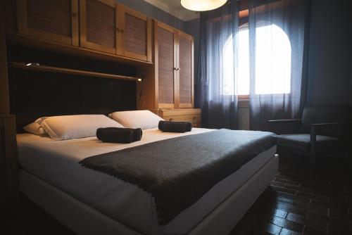 a bedroom with a bed with two bags on it at Casa di Luca in Torri del Benaco