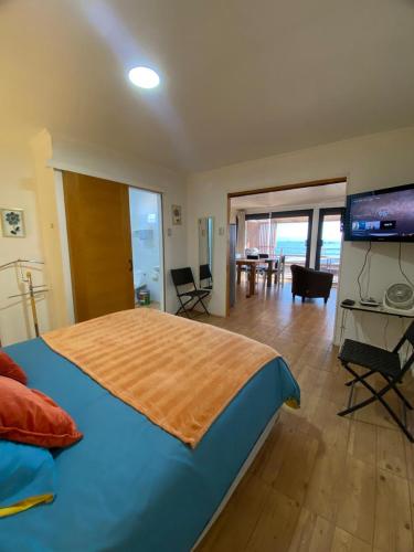 a bedroom with a large bed with a flat screen tv at Loft Tongoy 1 frente al mar in Coquimbo