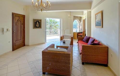 a living room with a couch and a table at Gorgeous Home In Lagonisi With Wifi in Lagonissi