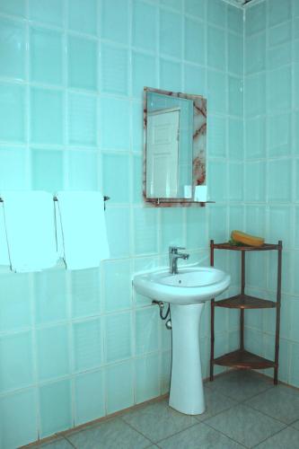 a bathroom with a sink and a mirror at Harmony house apartments in Ker Bakary
