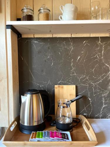 a wooden tray with a tea pot and a coffee maker at HealthyStudio512 Apartments in Kotor