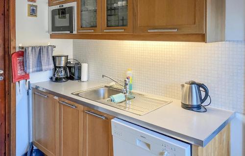 a kitchen with a sink and a counter top at 3 Bedroom Awesome Apartment In Mandal in Mandal