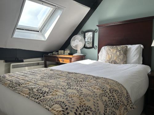 a bedroom with a large bed and a window at Sleeping Bear Hotels Dorchester in Dorchester