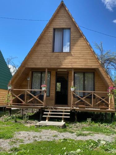 a log house with a porch and a door at Guesthouse Venera in Mestia