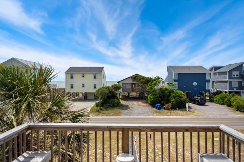 a view of the beach from the balcony of a house at Partial Oceanview 4BR,3BA, Sleeps 12 Steps to Beach Oak Island in Oak Island