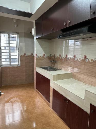 a kitchen with a sink and a counter top at Baridhara Sweet Home in Dhaka