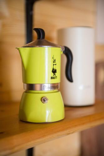 a yellow blender sitting on a counter next to a cup at The Stall at CasaClarig - West Cork Cabin with Sauna in Ballydehob