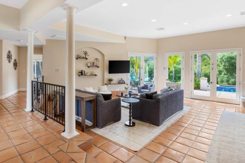 a living room with couches and a table at Grapevine by AvantStay Secluded 5BR Villa 4 Acres of Vineyards Avo Groves in Temecula