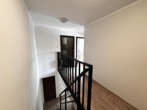 a staircase in a room with a white wall at Wektor Hostel in Ługów
