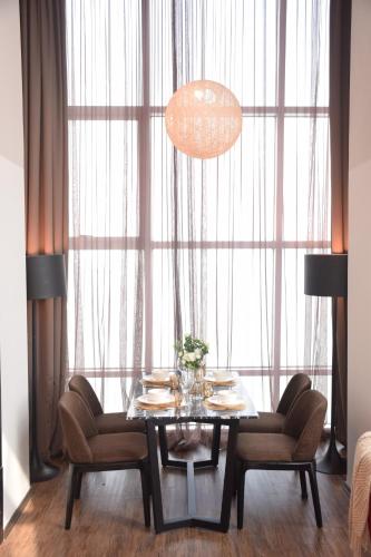 a dining room with a table and chairs and a large window at Maritime Suite by Ocean Luxe 2BR Seaview Dryer Water Dispenser in George Town