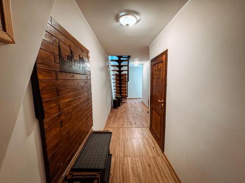 a hallway with a stairway with a door and a room at Wektor Hostel in Ługów