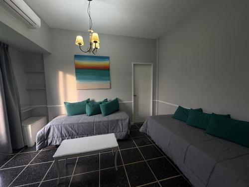 a living room with two beds and a couch at Hotel Lyon by MH in Buenos Aires