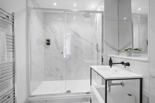 a white bathroom with a shower and a sink at 1 Bed - Napier by Pureserviced in Plymouth