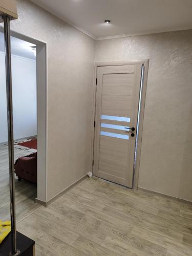 an empty room with a door and a bedroom at Квартира в центре Балки, город Тирасполь in Crăsnăşeni