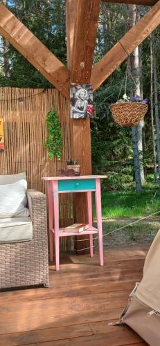 a pink table and a chair on a patio at Miami Jungle Glamping in Korjuse