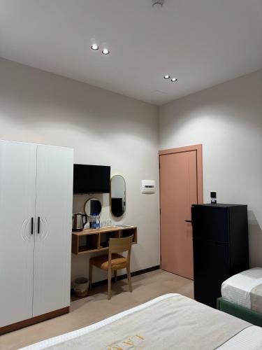 a bedroom with a desk and a bed and a desk at Villa La Mer Durres in Durrës