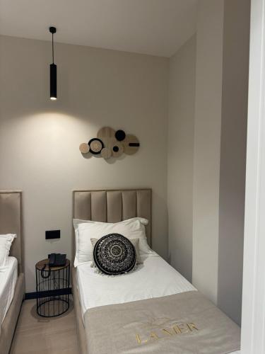 a bedroom with a bed with a pillow on it at Villa La Mer Durres in Durrës