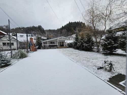 a driveway covered in snow in a house at WHITE HOUSE, Vidraru in Căpăţîneni-Pămînteni