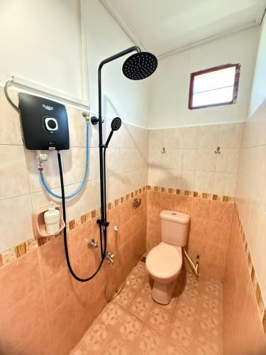 a bathroom with a shower with a toilet in it at STANDARD ROOM for 2Pax at Anggerik Impian Hotel Kuala Berang in Kuala Berang
