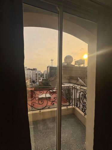 a window view of a city from a balcony at Hotel Lyon by MH in Buenos Aires