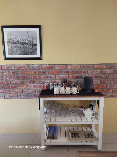 a white counter with a brick wall behind it at Country Breez Inn - Port Elizabeth in Gqeberha