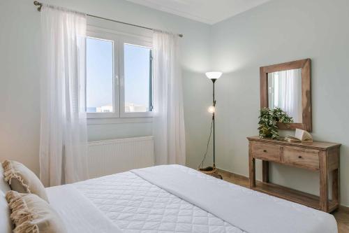 a bedroom with a bed and a mirror and window at Villa Alba Minies in Minia