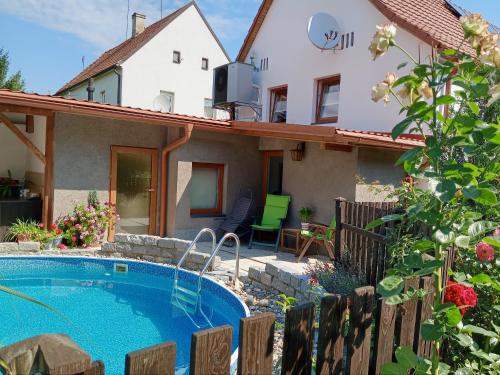 a villa with a swimming pool in front of a house at Apartmán Maria in Litoměřice