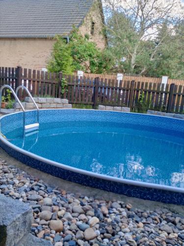 a swimming pool in a yard next to a fence at Apartmán Maria in Litoměřice