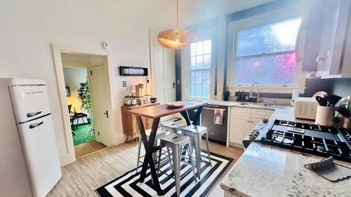 a kitchen with a table in the middle of a kitchen at Hollywood Glam Themed Manor with Sauna for 12-People in Lancaster
